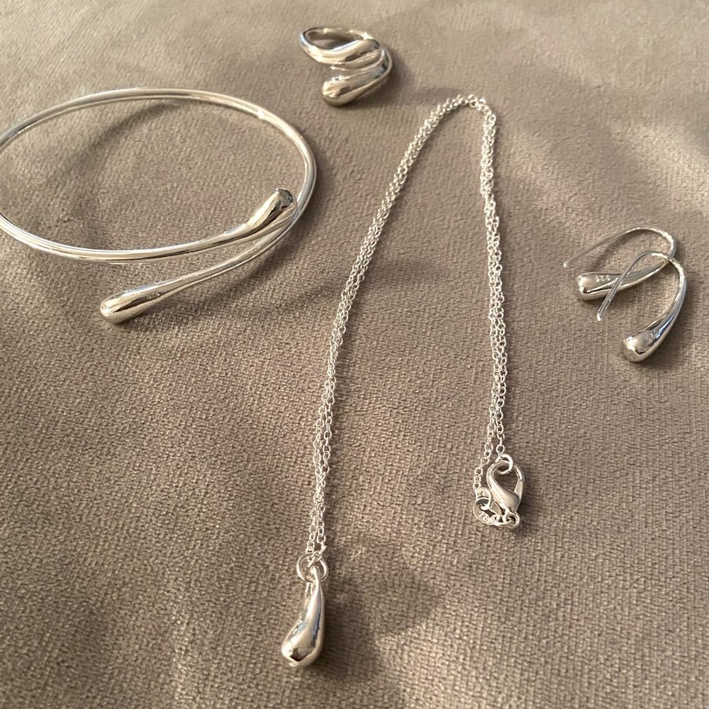 Ladies 4 piece matching jewelry set.  Silver with Rhodium Coating